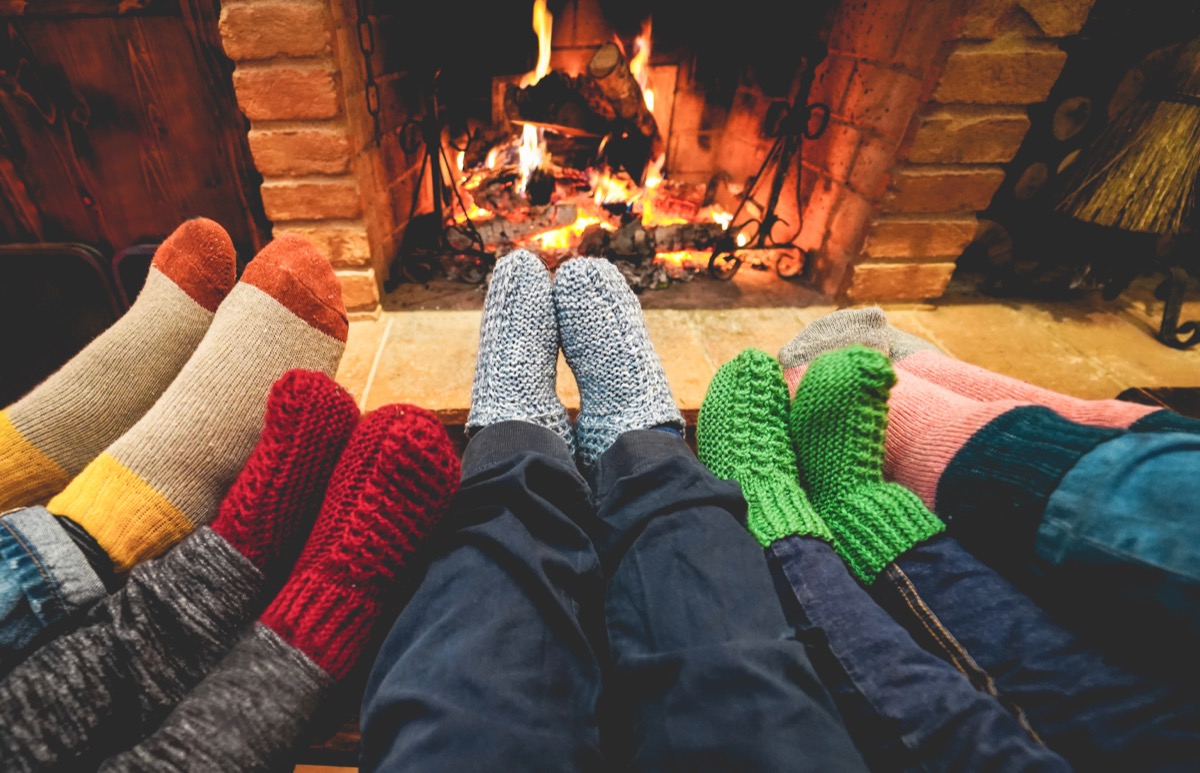 Family relaxing by a fireplace installed by The Fireplace Center of Indianapolis