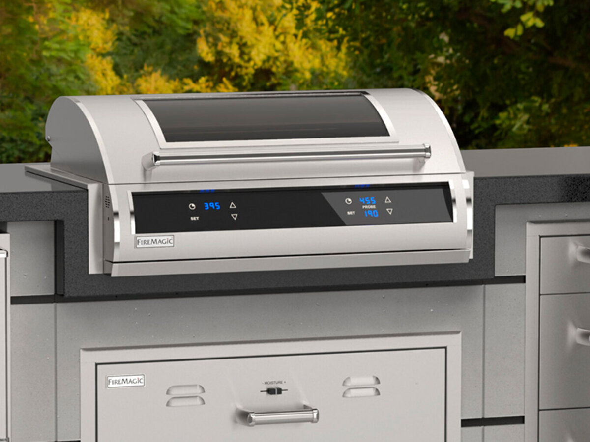 Fire Magic built-in grill set into a stainless outdoor kitchen island
